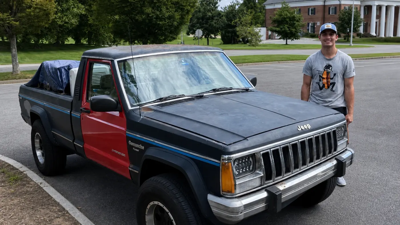 Charles Clark standing next to the restored 1987 Jeep Comanche in a parking lot